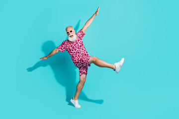 Full length photo of handsome bearded grandpa dancing flying dressed stylish pink leopard print garment isolated on cyan color background