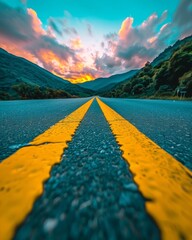 Scenic desert road at sunset with vibrant pink and orange sky overlooking the horizon