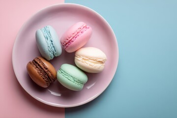 Fototapeta premium A top view of a pastel plate with three colorful macarons placed on it, creating a visually appealing and delicious dessert display.