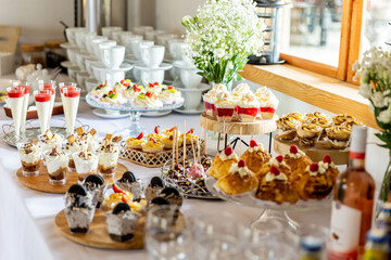 Dessert buffet or candy bar during catering event, fruits and whipped cream