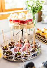 Dessert buffet or candy bar during catering event, fruits and whipped cream