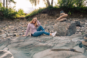 Woman at the river Katun at summer day. Trip on Altai Mountains in Altai Republic