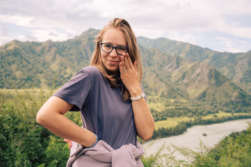Woman at the river Katun at summer day. Trip on Altai Mountains in Altai Republic