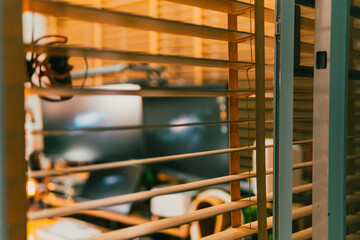 Modern cinematic desk setup with triple monitor, gaming chair, ambient light, and cozy atmosphere for work or gaming.