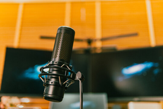 Modern cinematic desk setup with triple monitor, gaming chair, ambient light, and cozy atmosphere for work or gaming.