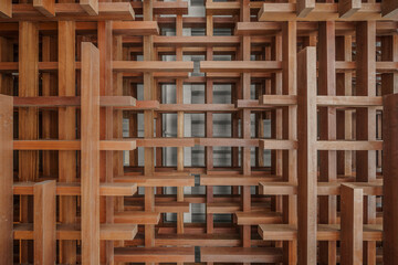 Abstract architectural detail of an interlocking wooden lattice. The 3D geometric structure creates...