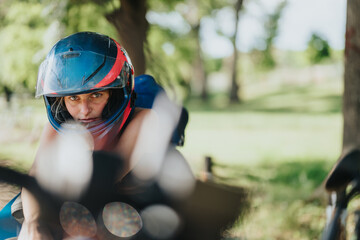 A close-up of a motorcyclist wearing a helmet, with a natural outdoor background, exuding...