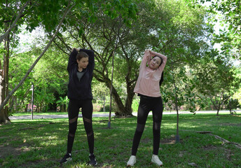 Female friends who are getting ready to run and stretch, exercise, run or enjoy nature with friends who are warming up before exercising, fitness.