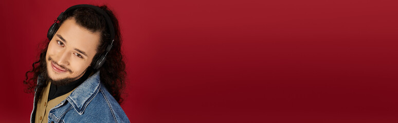 Captivating moment with young bearded man wearing headphones in a vibrant backdrop