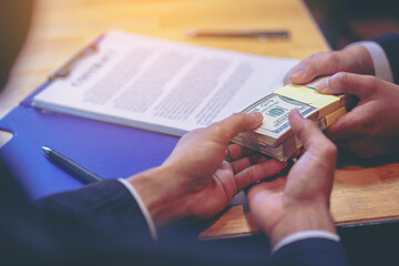Banker offering loan money for customer and signing a loan contract. Selected focus