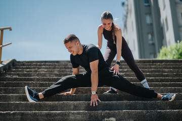 A man and woman engage in an outdoor exercise session on stairs, performing stretching routines...
