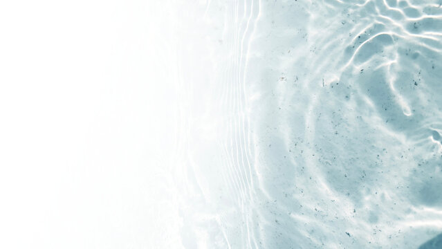 Transparent water waves in sunlight background.	
Trendy summer nature banner. Defocused aqua-mint liquid colored clear water surface texture with splashes bubbles with copy space. 