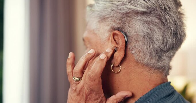 Hands, senior woman and hearing aid in house with implant, test and fitting mould for comfort in retirement. Back, listen and medical tech for elderly person with disability, deaf and audio at home