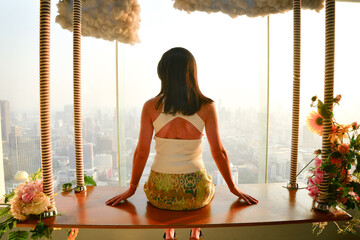 Pretty caucasian woman tourist stand behind glass window isolated enjoying beautiful sunset...