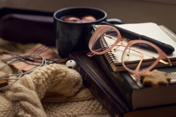 Object photography. On the windowsill lie book, Notepad, pen, glasses case, cookies, termoz and mug...