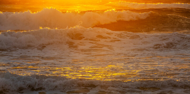 Rough sea with waves at sunrise