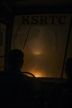 KSRTC bus travelling through a forest route in the night.