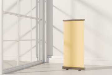Modern blank yellow banner stand in bright room with window light. 3d rendering