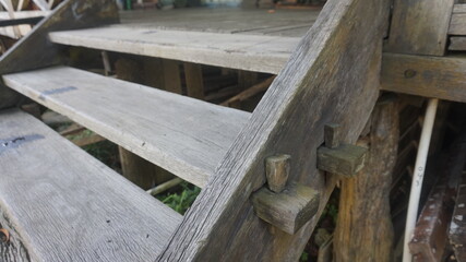 Close-up of weathered wooden stairs with traditional joinery