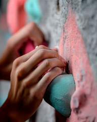 Woman’s Hand Gripping Indoor Climbing Hold