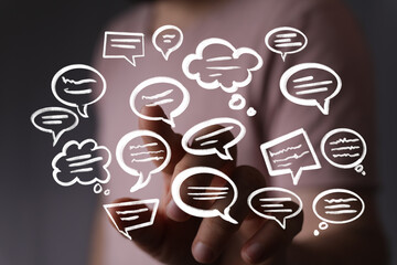 Hand interacting with floating speech bubbles,communication, conversation, digital interaction...