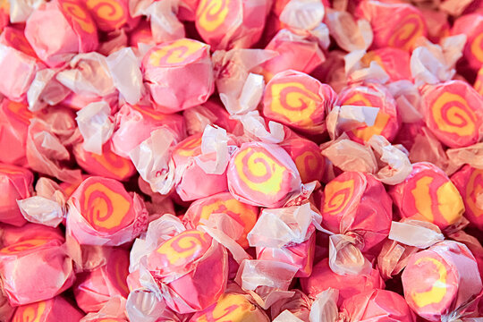 Close-up of pink and yellow taffy candies