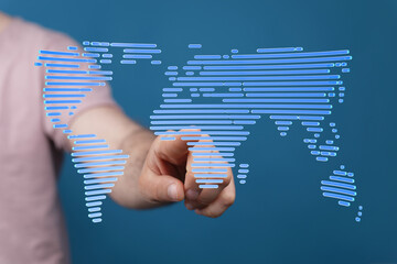 Person's hand interacts with a digital world map, symbolizing global connectivity and networking.