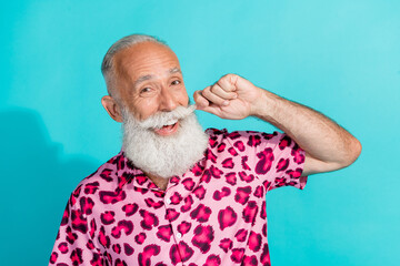 Photo of funny aged man hand touch mustache wear leopard print outfit isolated on teal color...