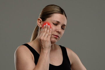 Woman Experiencing Severe Facial Pain with Highlighted Area in Red