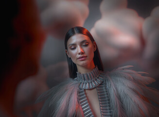  a person wearing an elaborate, feathered gown with metallic embellishments. The background is blurred, with warm reddish tones and abstract shapes.
