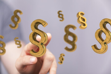 High-quality stock photo of a hand interacting with golden paragraph symbols, perfect for legal and law-related projects.