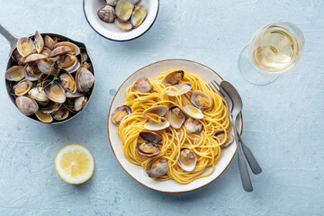 Vongole clams with spaghetti pasta, with white wine, overhead flat lay shot. Seafood linguine with lemon and thyme
