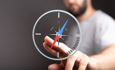 A man interacts with a virtual compass, representing guidance and direction. Ideal for business,...