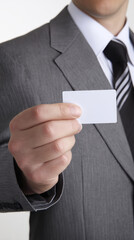 Businessman in Formal Suit Holding Blank Business Card in Office Setting