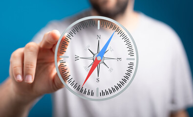 A man holds a digital compass, symbolizing guidance, direction, and finding your way.