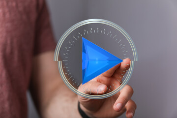 Abstract image of a hand interacting with a digital play button interface.
