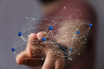Abstract image of a hand interacting with a complex network, representing digital connections and...