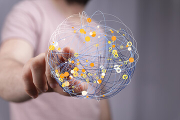 Image of a hand interacting with a digital sphere representing global connections and data networks.