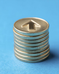 Stack of Golden Coins with Arrow Symbol Representing Financial Growth and Investment Opportunities