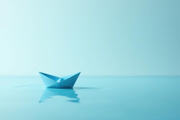 A small, light blue paper boat floats serenely on a calm, tranquil body of water, reflecting the sky.