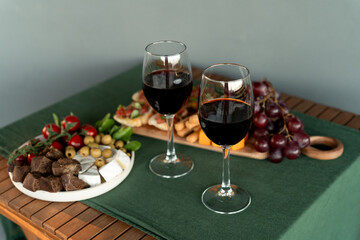 Still life of  Red wine and charcuterie setup on wooden patio table