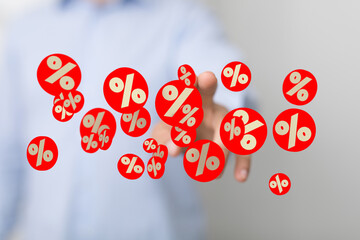 Image of hand interacting with percentage symbols, ideal for finance, sales, discount concepts.