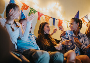 A cheerful gathering of family members enjoying a birthday celebration featuring vibrant...