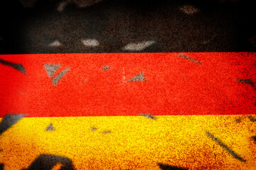 Grunge and damaged Germany national flag on the wall.
