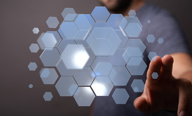Abstract image of a person interacting with a digital hexagon interface.  Perfect for technology,...