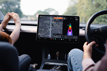 Woman drive EV car use GPS navigator on road