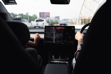 Woman drive EV car use GPS navigator on road