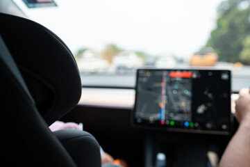 Woman drive EV car use GPS navigator on road
