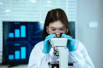 Scientist analyzes biological samples using advanced laboratory equipment for medical research,...