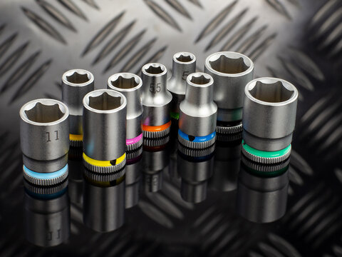 Set of Color Coded Socket Wrenches on Black Surface